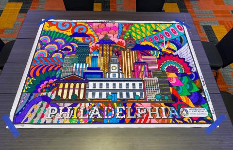 A photo of a poster colored in by event participants showing Philadelphia City Hall